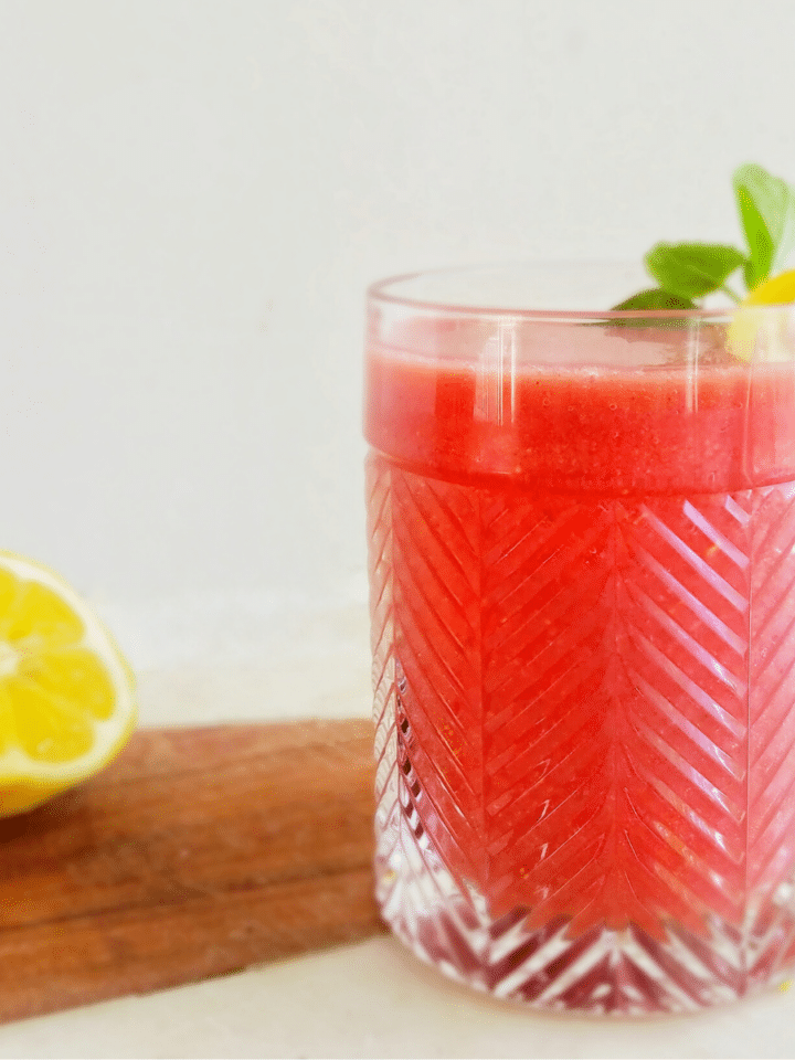 frozen strawberry maple bourbon lemonade with lemon wedge recipe found on mandyolive.com