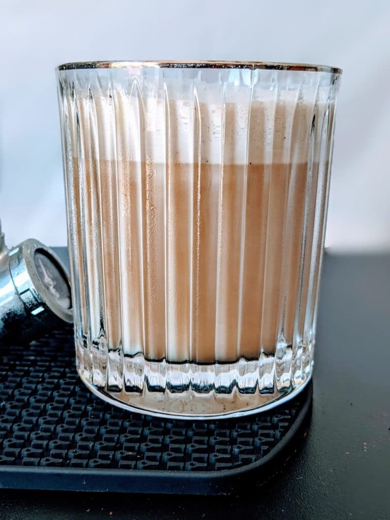 starbucks nitro cold brew with sweet cream in gold rimmed glass