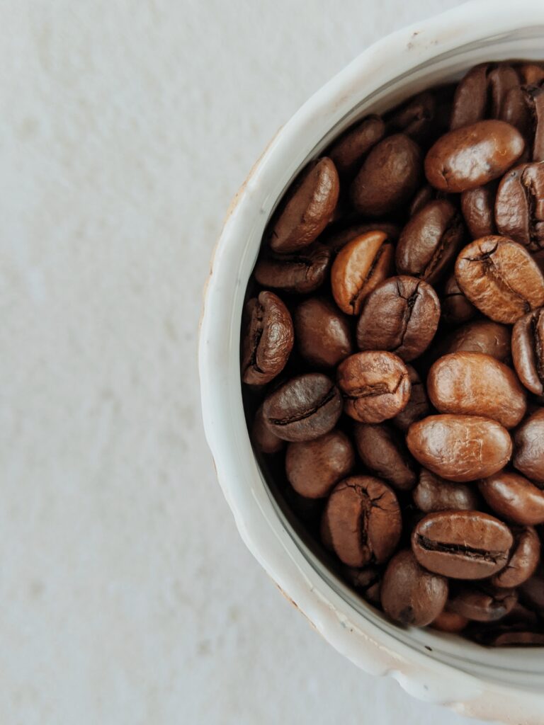 coffee beans in cup depicted for detailed post on espresso grind settings. A guide to espresso grind size. 