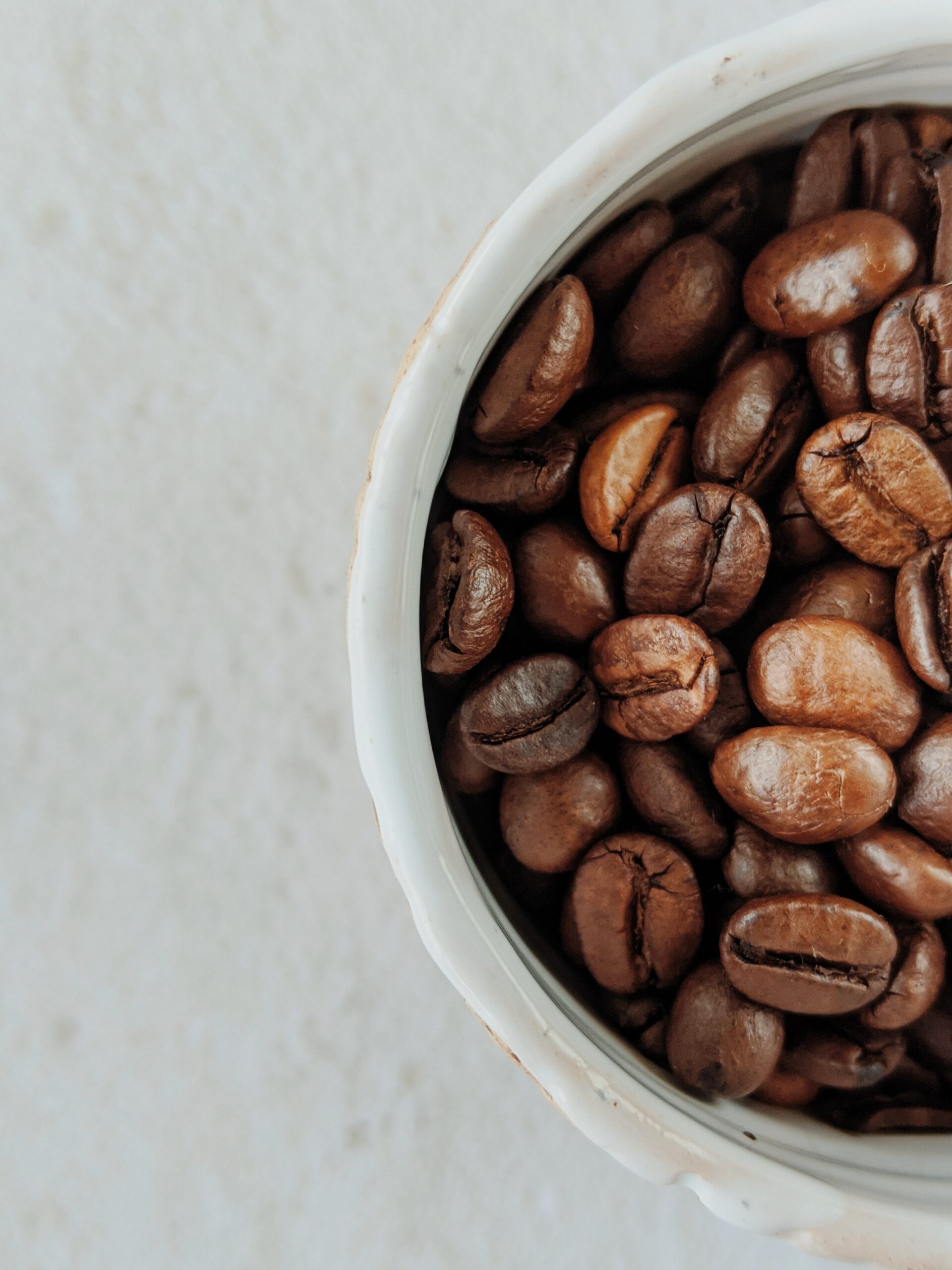 Coffee Beans Inside Shot Glass On Weight Scale With Empty Coffee