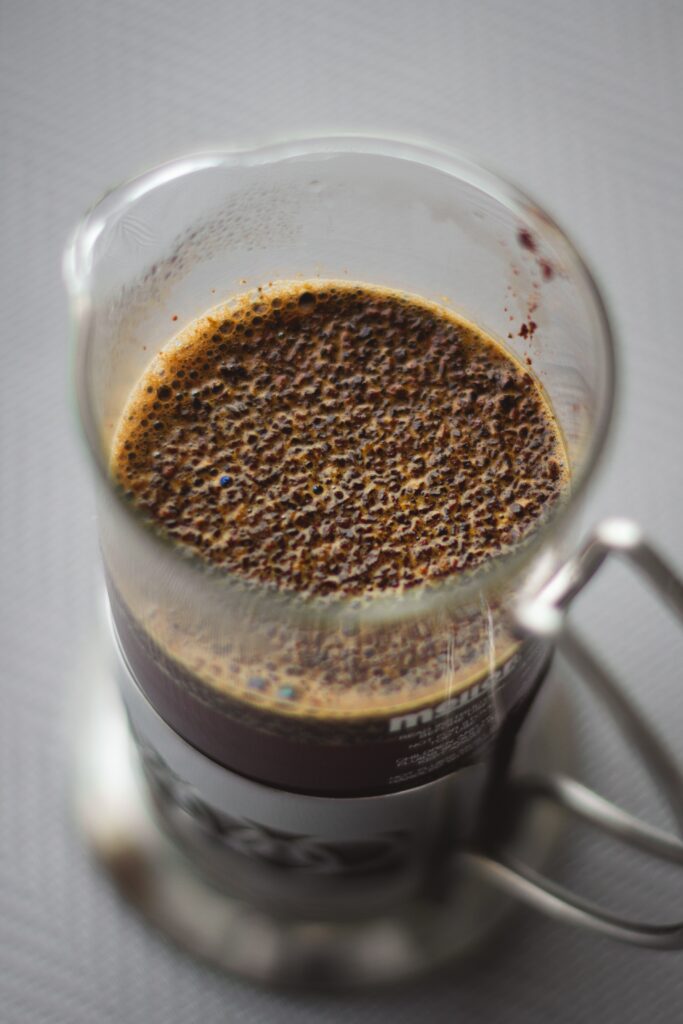 how to make a starbucks apple crisp macchiato. pictured is a french press filled with coffee.