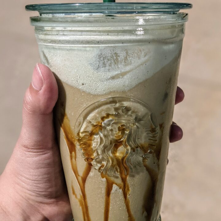 Salted caramel cream nitro cold brew starbucks copycat recipe in a starbucks cold cup with caramel drizzle and vanilla sweet cream.