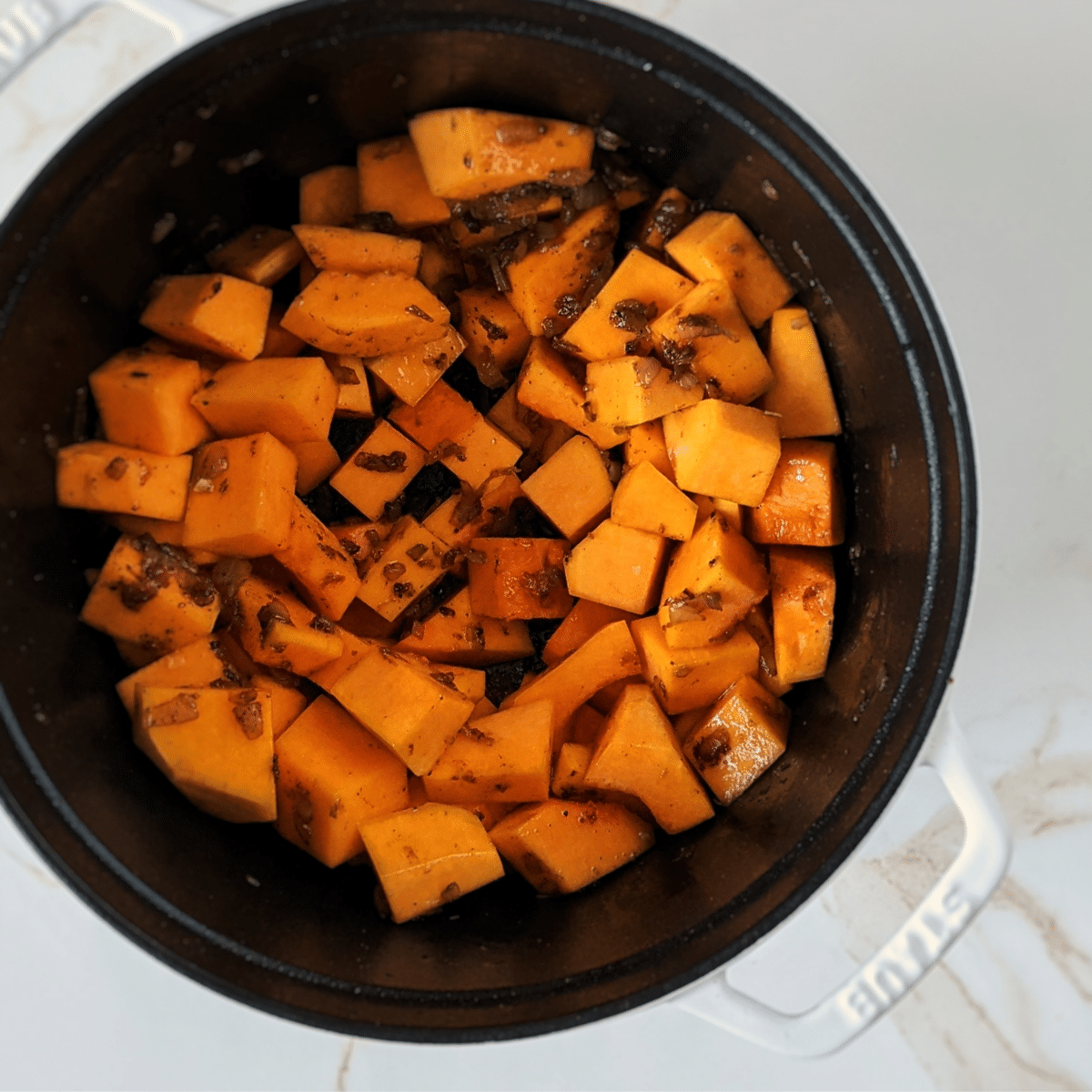 butternut squash in white staub dutch oven  recipe found on mandyolive.com.