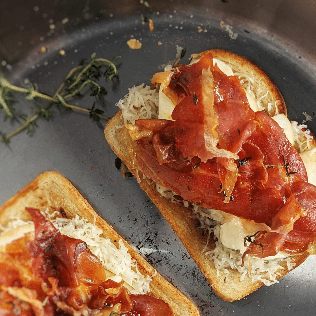 assembling apple gouda grilled cheese sandwiches with crisp prosciutto in stainless steel pan