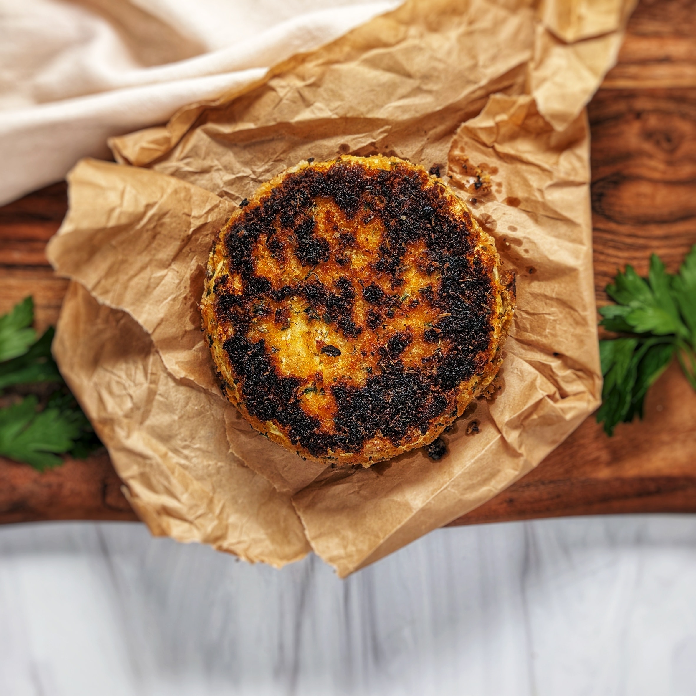 fried brie wheel on top of brown paper