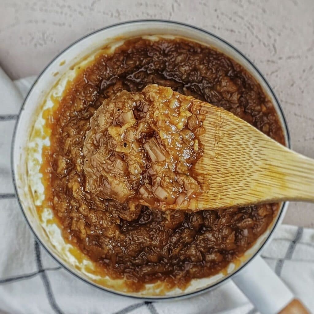 onion jam shown on spoon in dansk pot