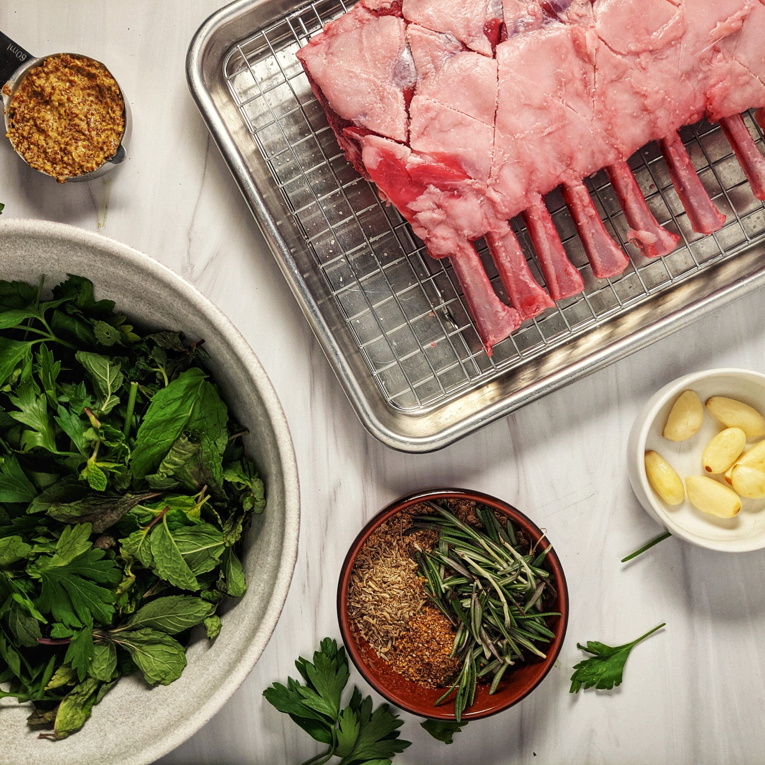 ingredients for holiday lamb, rack of lamb, parsley, mint, garlic, mustard, spices