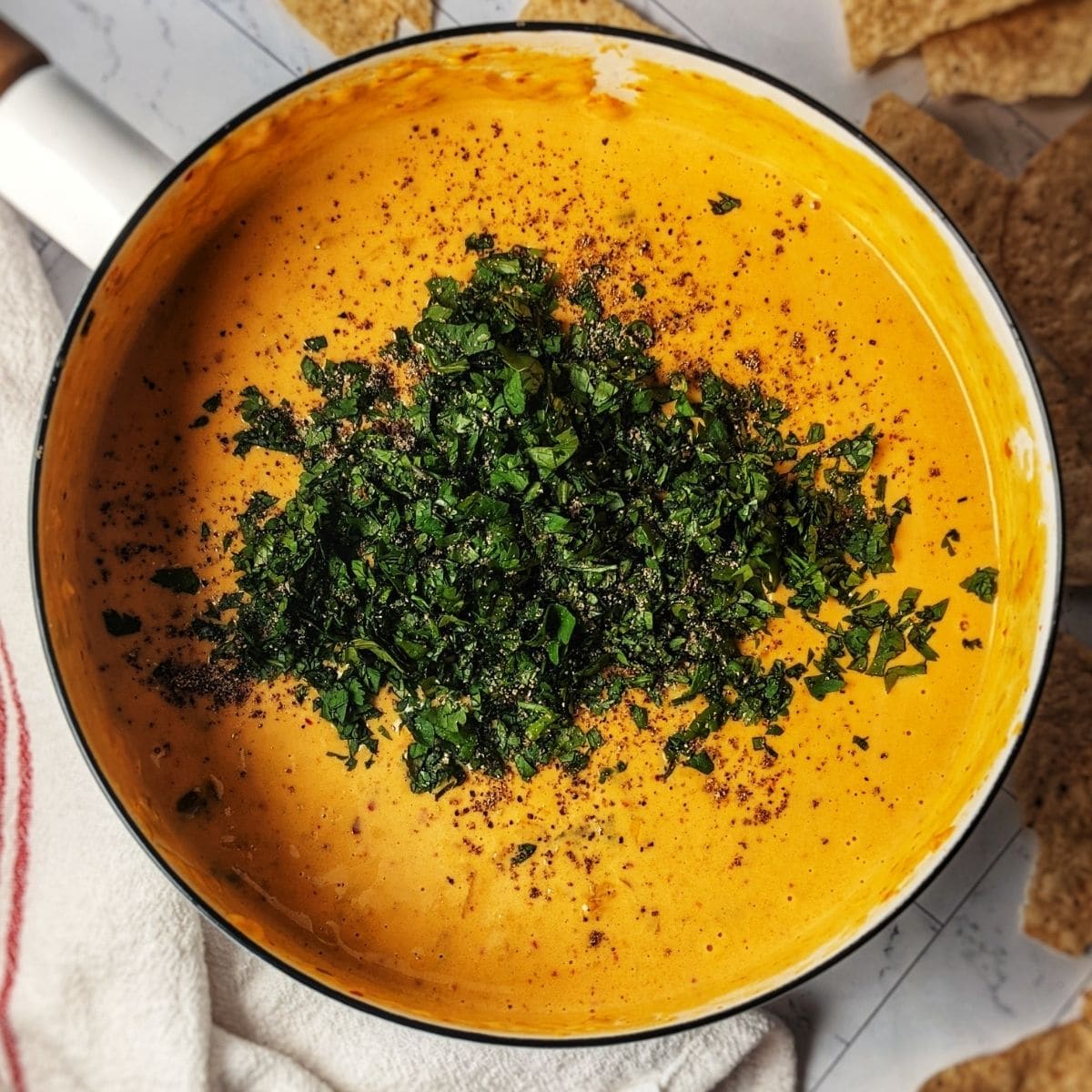 kimchi queso recipe in dansk saucepan garnished with cilantro. 