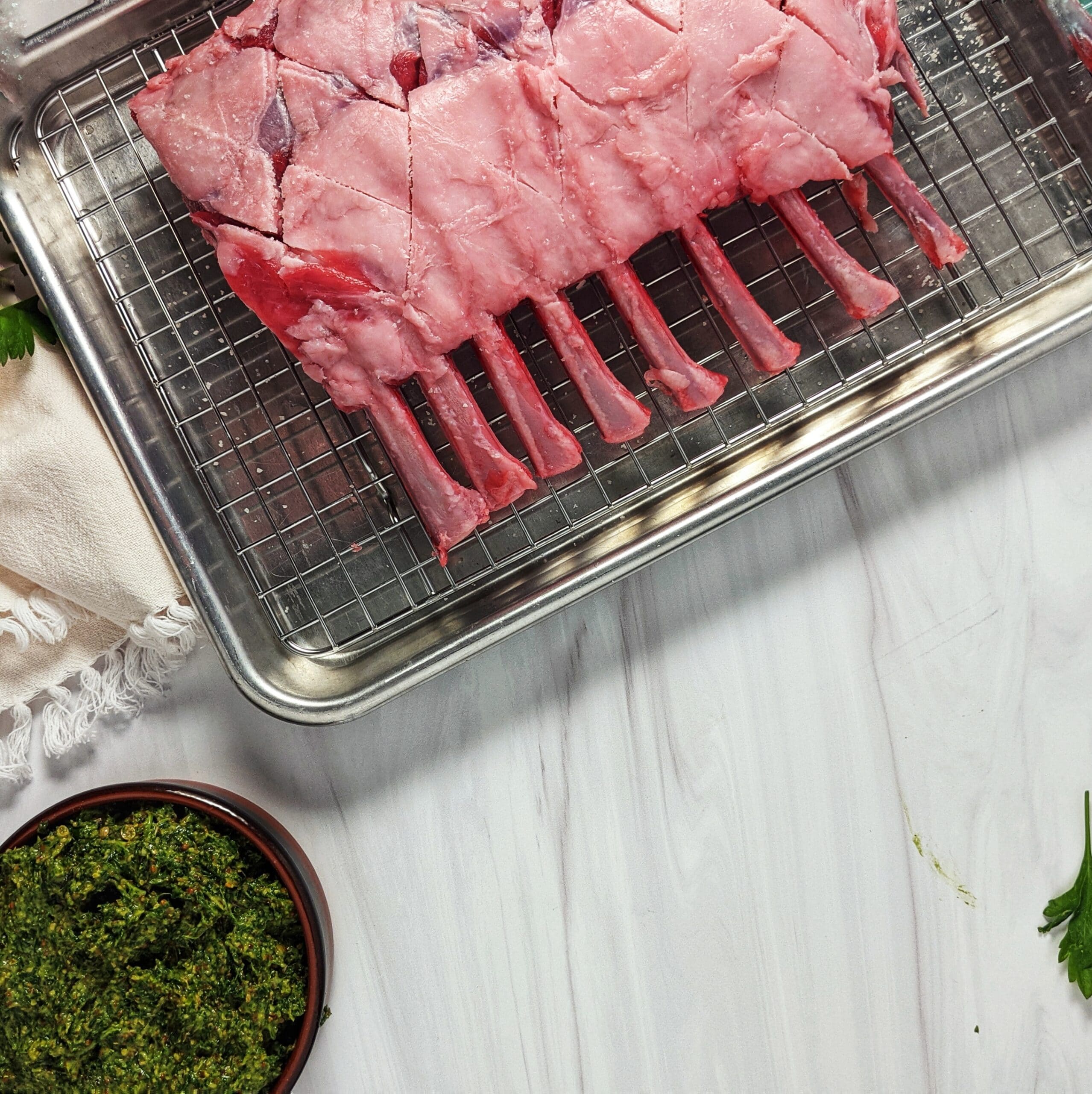 rack of lamb with herb rub ready to spread