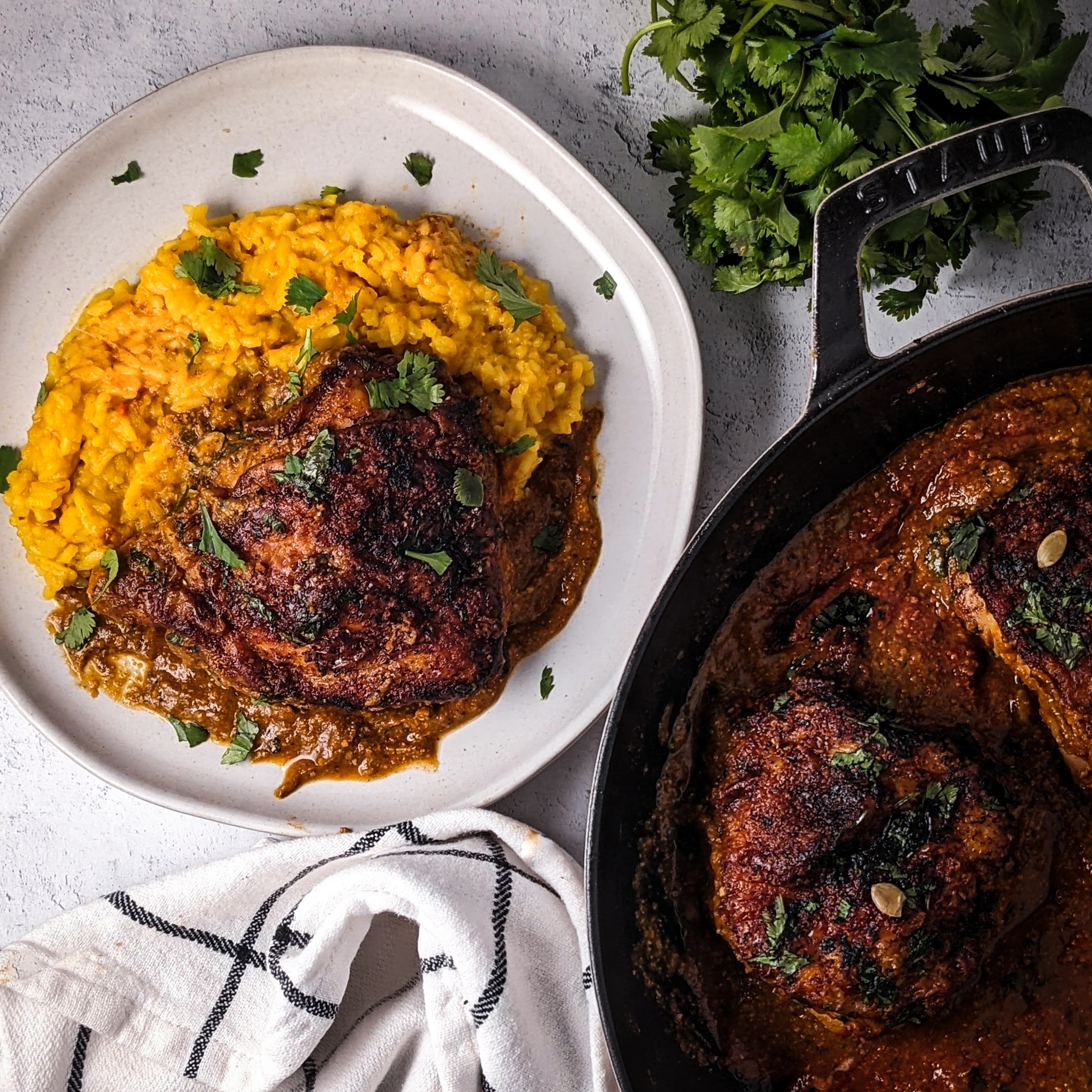 pepita mole with lime chicken thighs in pan on bottom right. lime chicken thighs served with saffron rice. 